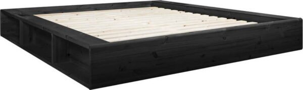 Černá dvoulůžková postel z masivního dřeva s úložným